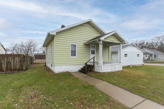 bungalow-style home featuring a front lawn