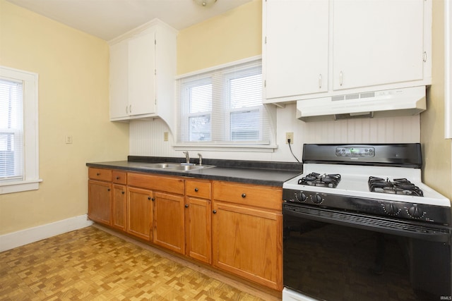 kitchen featuring sink, light parquet floors, gas stove, and white cabinets