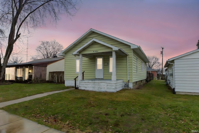 bungalow-style home with a yard