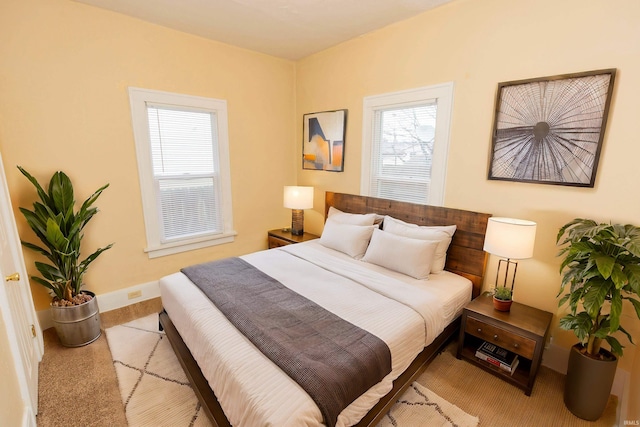 carpeted bedroom with multiple windows