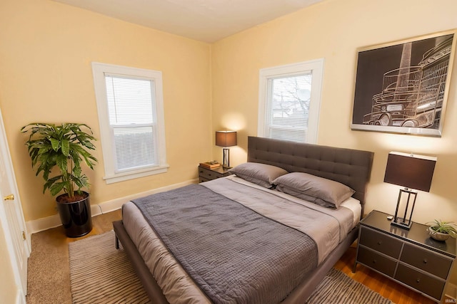 bedroom featuring multiple windows and hardwood / wood-style floors