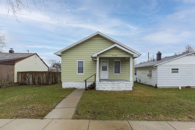 bungalow-style house with a front lawn