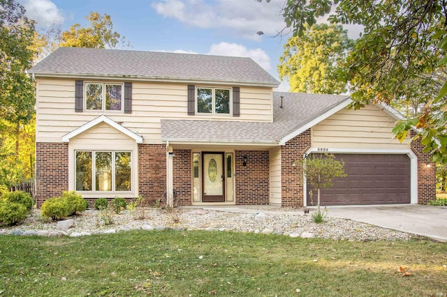 front of property featuring a garage and a front lawn