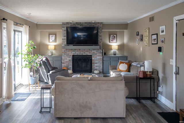 living room featuring dark hardwood / wood-style flooring, a fireplace, ornamental molding, and a textured ceiling