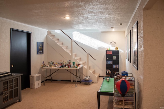 rec room with crown molding, carpet flooring, and a textured ceiling