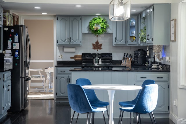 kitchen with gray cabinets, pendant lighting, decorative backsplash, stove, and stainless steel refrigerator with ice dispenser