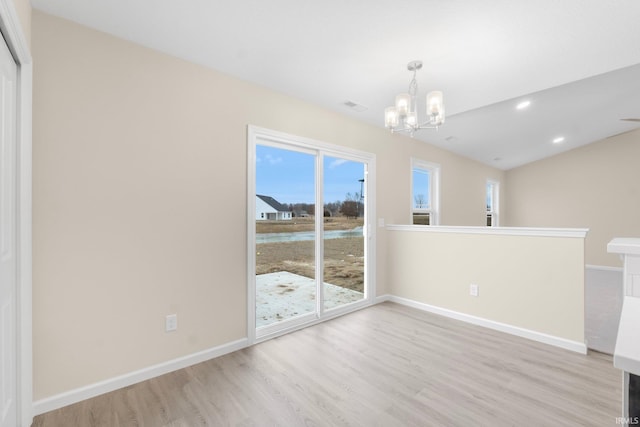 unfurnished dining area with an inviting chandelier and light wood-type flooring