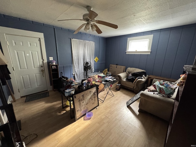 living room with ceiling fan and light wood-type flooring