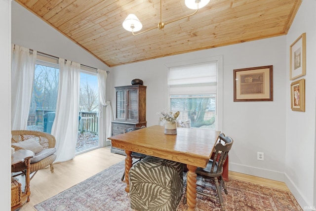 dining space featuring wood ceiling, vaulted ceiling, and light hardwood / wood-style floors