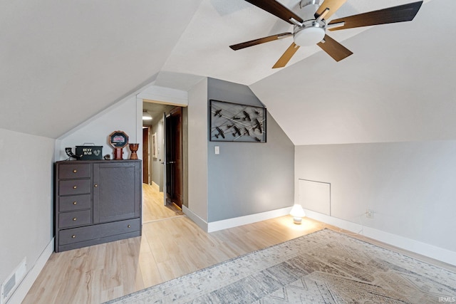 additional living space with light hardwood / wood-style flooring, ceiling fan, and vaulted ceiling