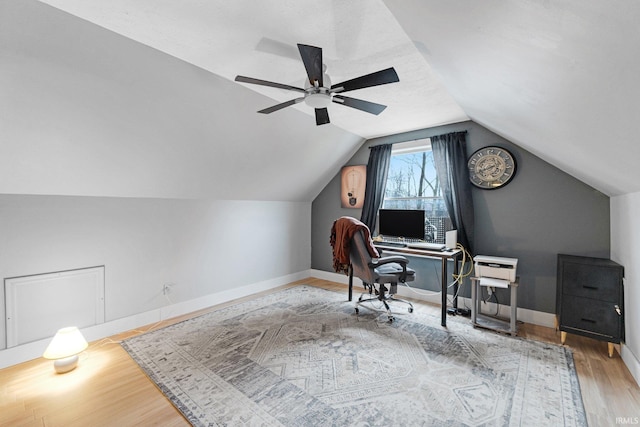 office area featuring ceiling fan, vaulted ceiling, and light hardwood / wood-style flooring