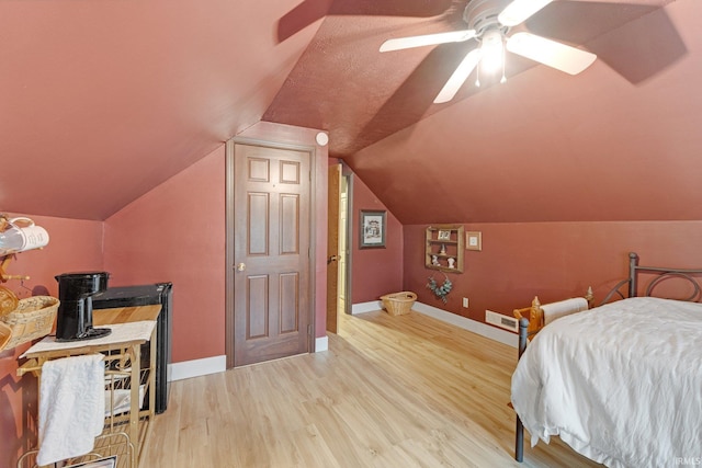 bedroom featuring vaulted ceiling, light hardwood / wood-style floors, and ceiling fan