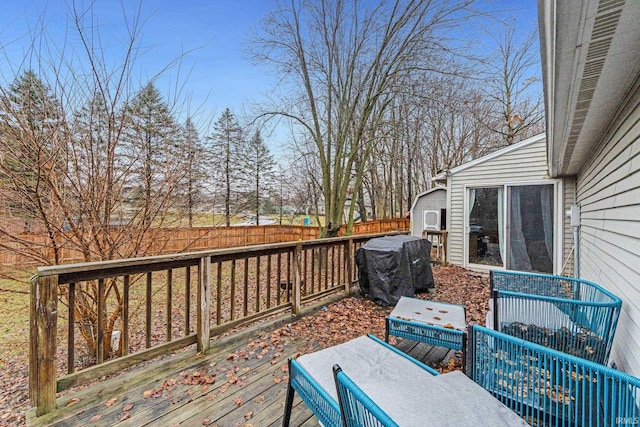 wooden deck featuring a grill