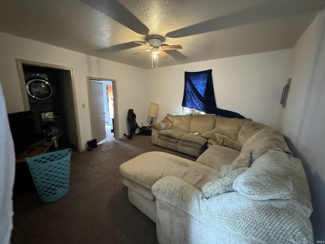 carpeted living room with stacked washer / dryer, a textured ceiling, and ceiling fan