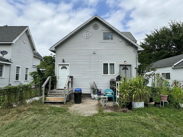 back of house with a lawn