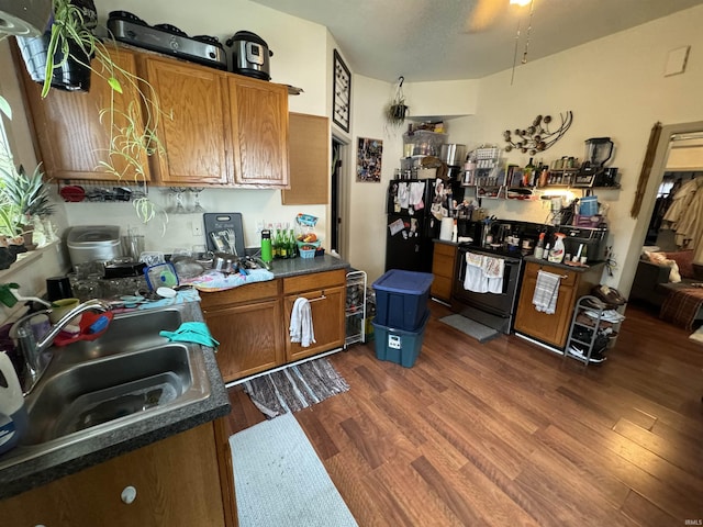 kitchen with dark wood-type flooring, sink, and range with electric cooktop