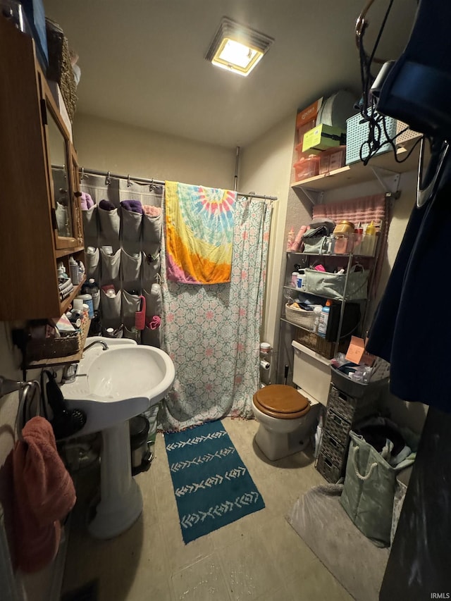 bathroom with toilet and curtained shower