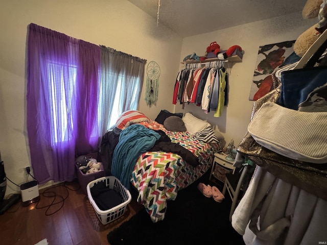 bedroom with hardwood / wood-style flooring