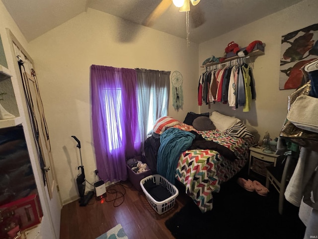 bedroom featuring hardwood / wood-style flooring, vaulted ceiling, and ceiling fan