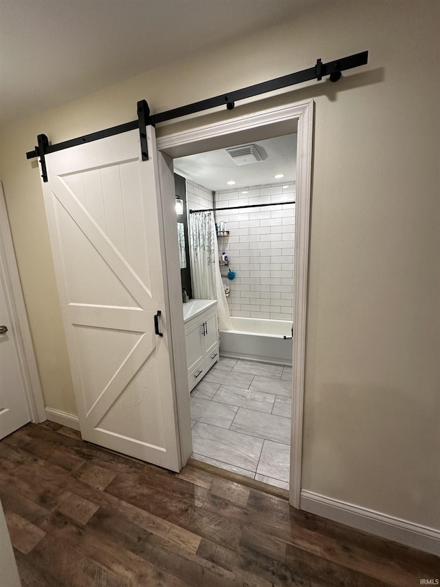 bathroom featuring hardwood / wood-style flooring and shower / tub combo