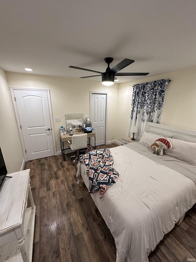 bedroom with dark hardwood / wood-style flooring, a closet, and ceiling fan