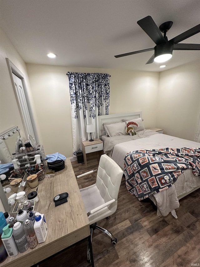 bedroom with ceiling fan and dark hardwood / wood-style flooring