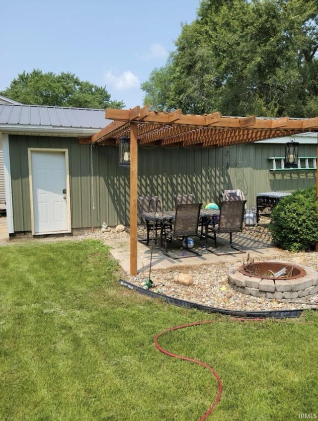 back of house featuring a pergola, a lawn, a patio, and an outdoor fire pit