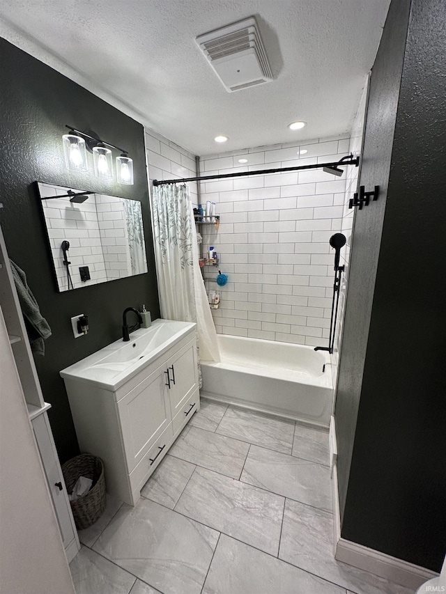 bathroom with vanity, a textured ceiling, and shower / bath combo