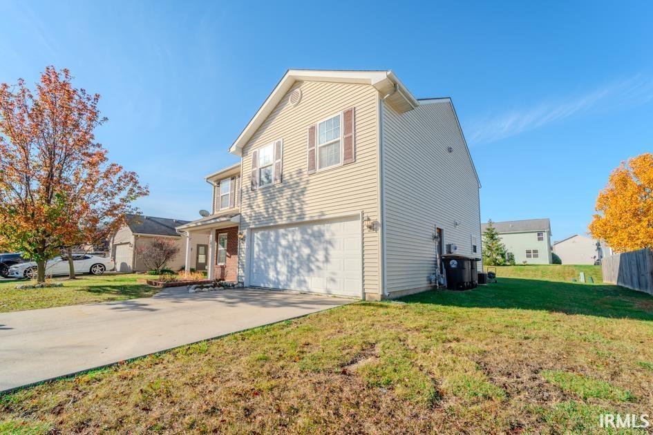 exterior space with a yard and a garage