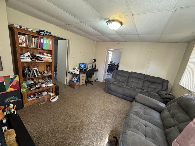 living room with carpet and a paneled ceiling