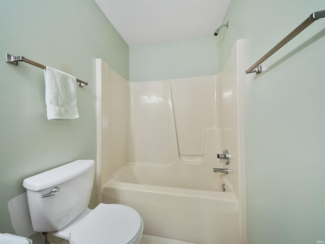 bathroom with toilet, a textured ceiling, and washtub / shower combination