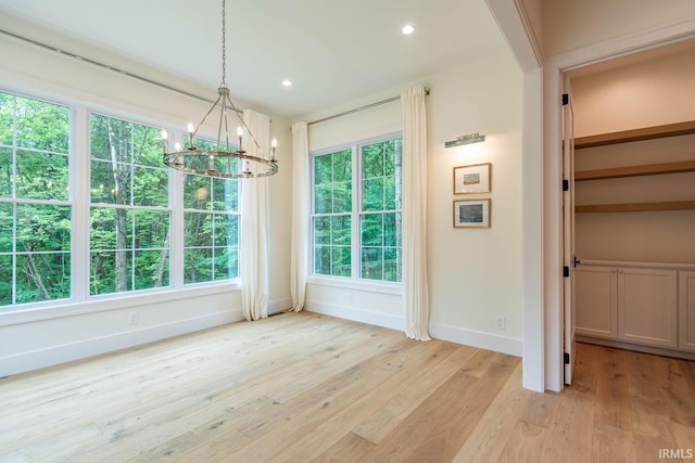 5026 N Muirfield Dr, Bloomington, IN 47404 - unfurnished dining area featuring an inviting chandelier and light hardwood / wood-style floors