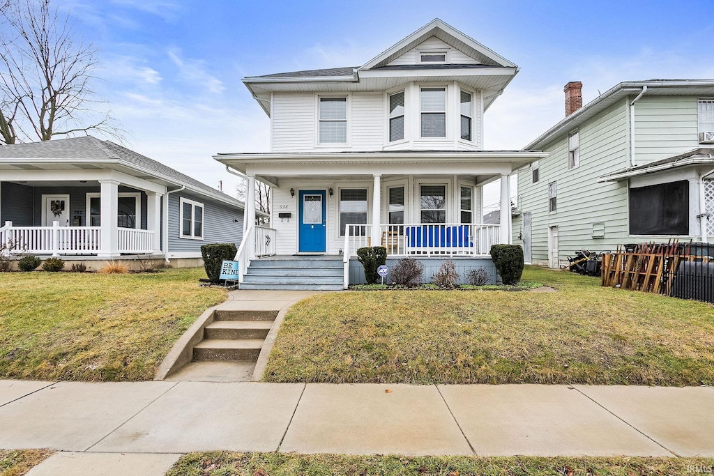 view of front of house featuring covered porch and a front lawn