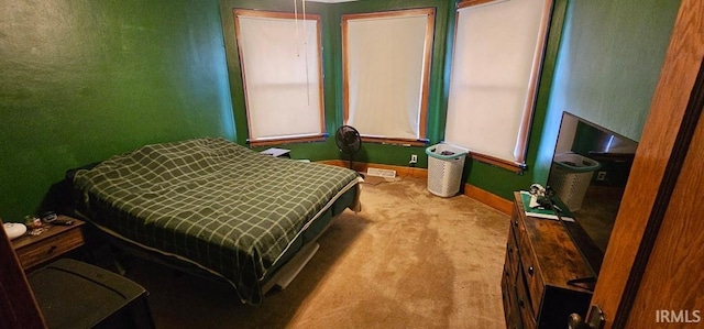 bedroom featuring light carpet