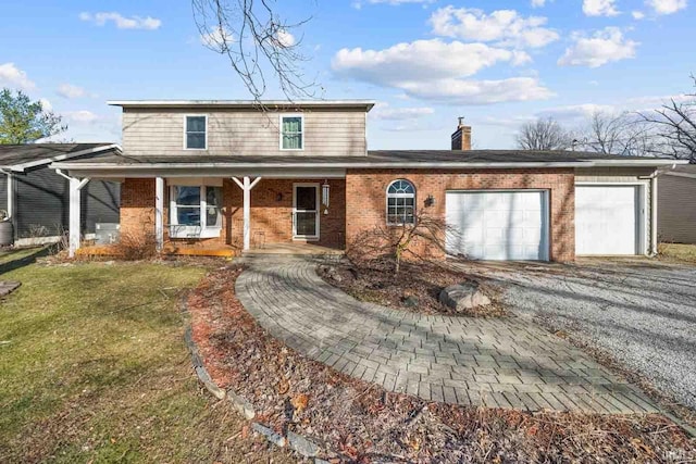 front of property with a garage, covered porch, and a front yard