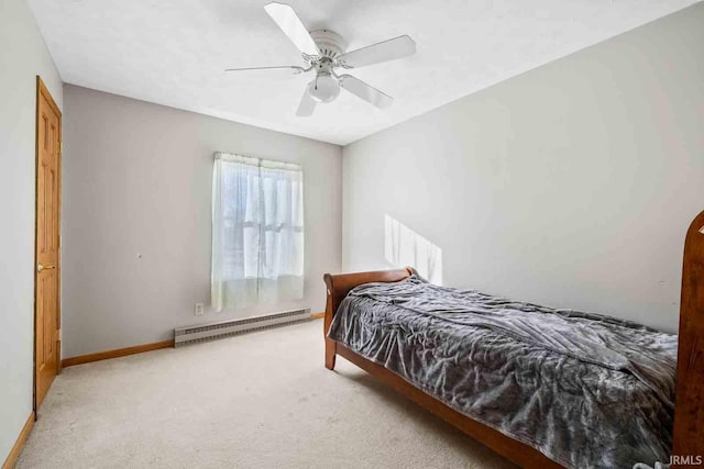 carpeted bedroom featuring ceiling fan and baseboard heating