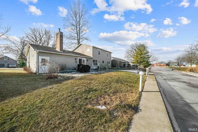 view of side of home with a lawn