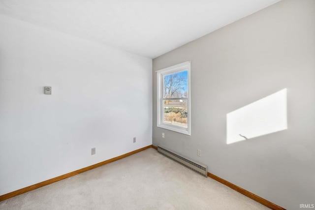 empty room with a baseboard radiator and light colored carpet