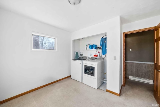 washroom with washing machine and dryer, light carpet, and baseboard heating