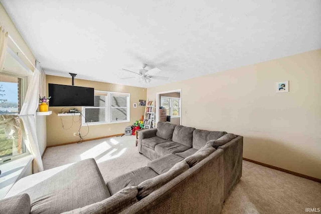 carpeted living room with plenty of natural light and ceiling fan