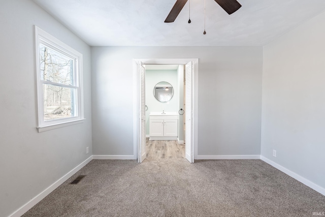 spare room with light carpet and ceiling fan