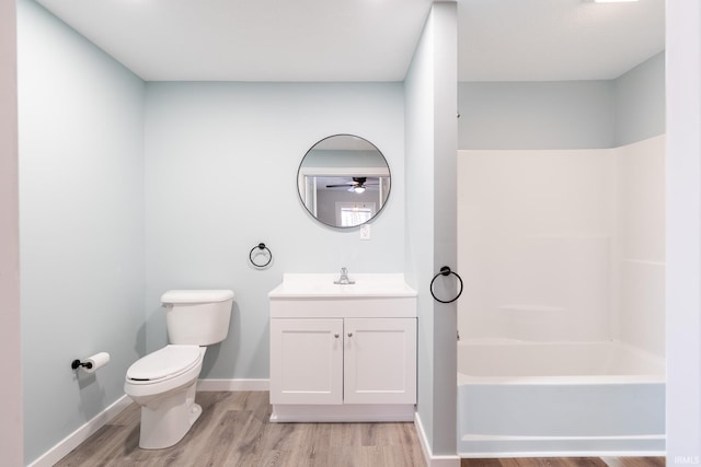 full bathroom with wood-type flooring, toilet, shower / bath combination, and vanity