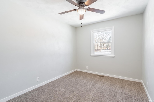 spare room with carpet and ceiling fan