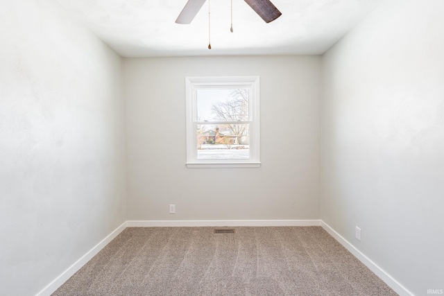 carpeted spare room with ceiling fan