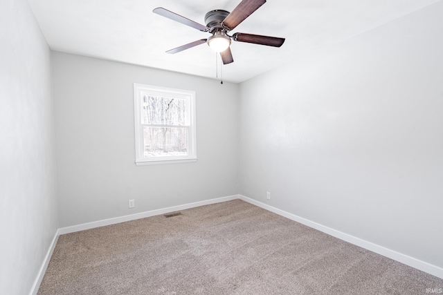 carpeted spare room with ceiling fan