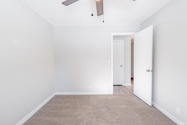 empty room with light colored carpet and ceiling fan