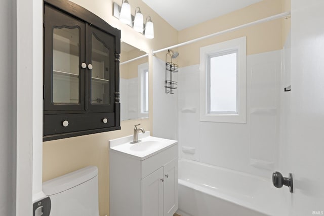 full bathroom with bathtub / shower combination, vanity, and toilet