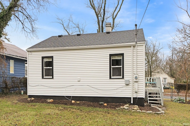 view of home's exterior with a wooden deck and a yard