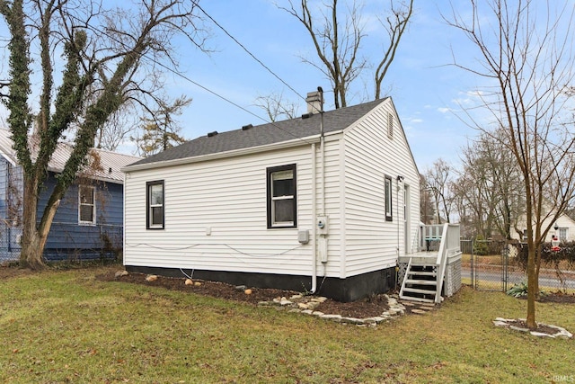 view of side of property with a yard and a deck