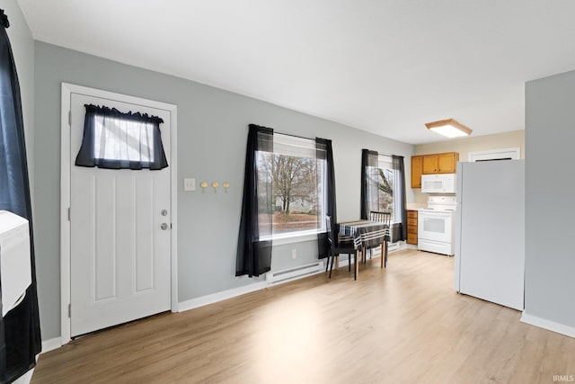 foyer featuring a baseboard radiator and light hardwood / wood-style floors